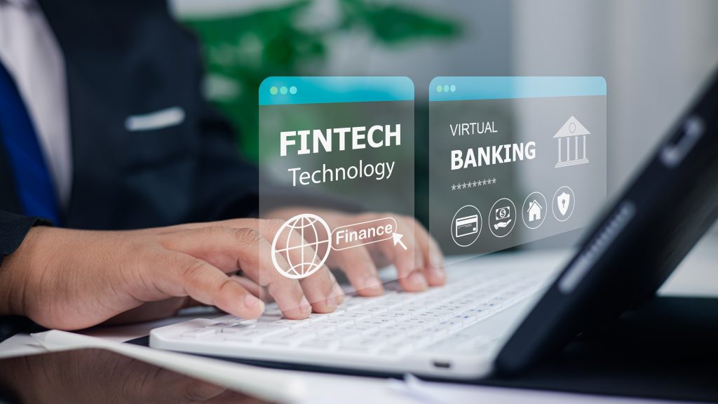 Businessman using laptop with fintech technology and virtual banking concept, digital finance innovation, online transactions, security, and future financial services for modern business growth.